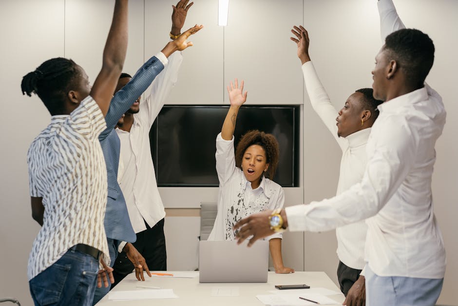 Group of diverse professionals raising hands