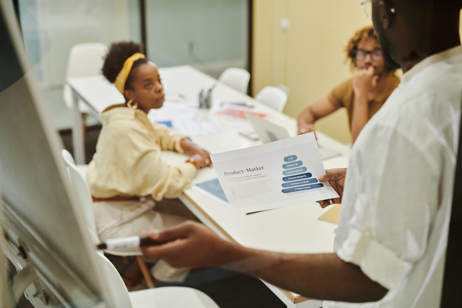 Three colleagues engaged in a collaborative discussion during a business meeting